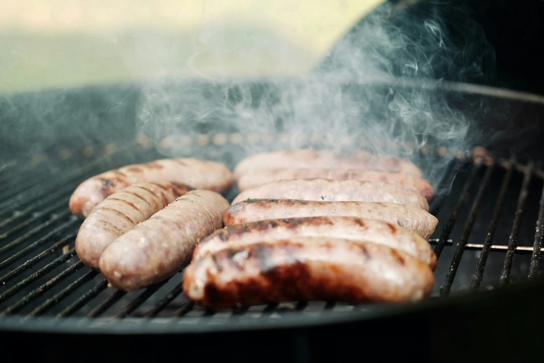 Sausage links browning on a grill