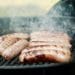 Italian sausages cooking on a grill