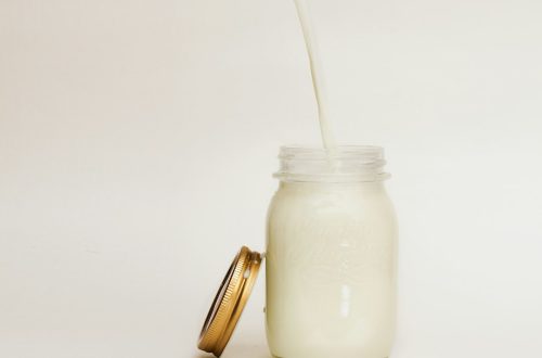 Milk poured into a glass jar, an ingredient for a heavy cream substitute for cooking
