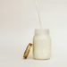 Milk poured into a glass jar, an ingredient for a heavy cream substitute for cooking
