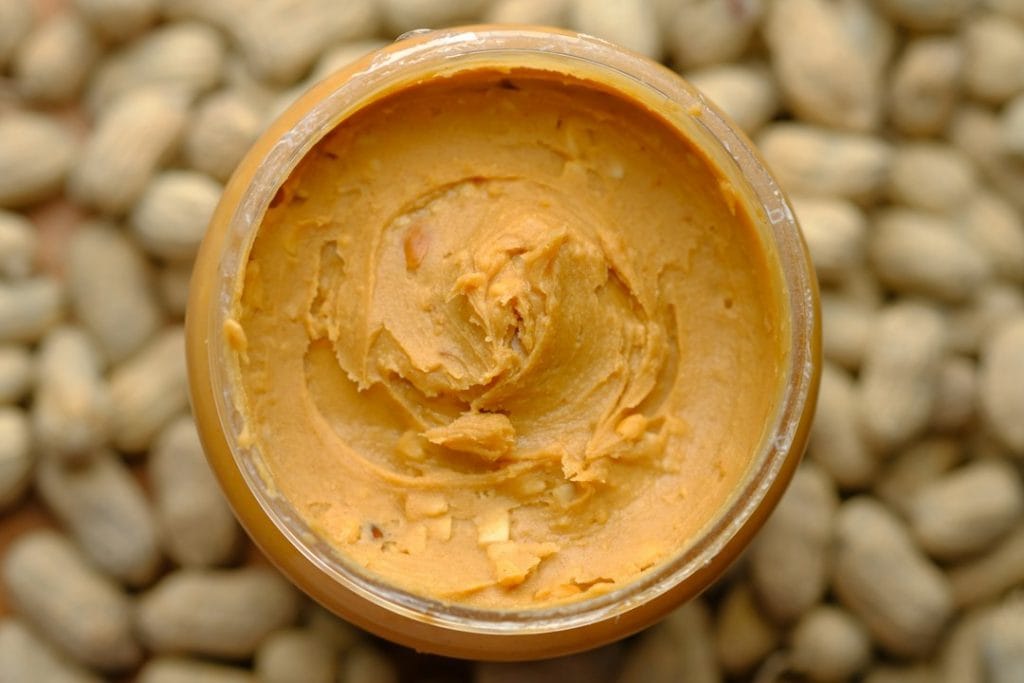 Peanut butter in a small container, viewed from above.