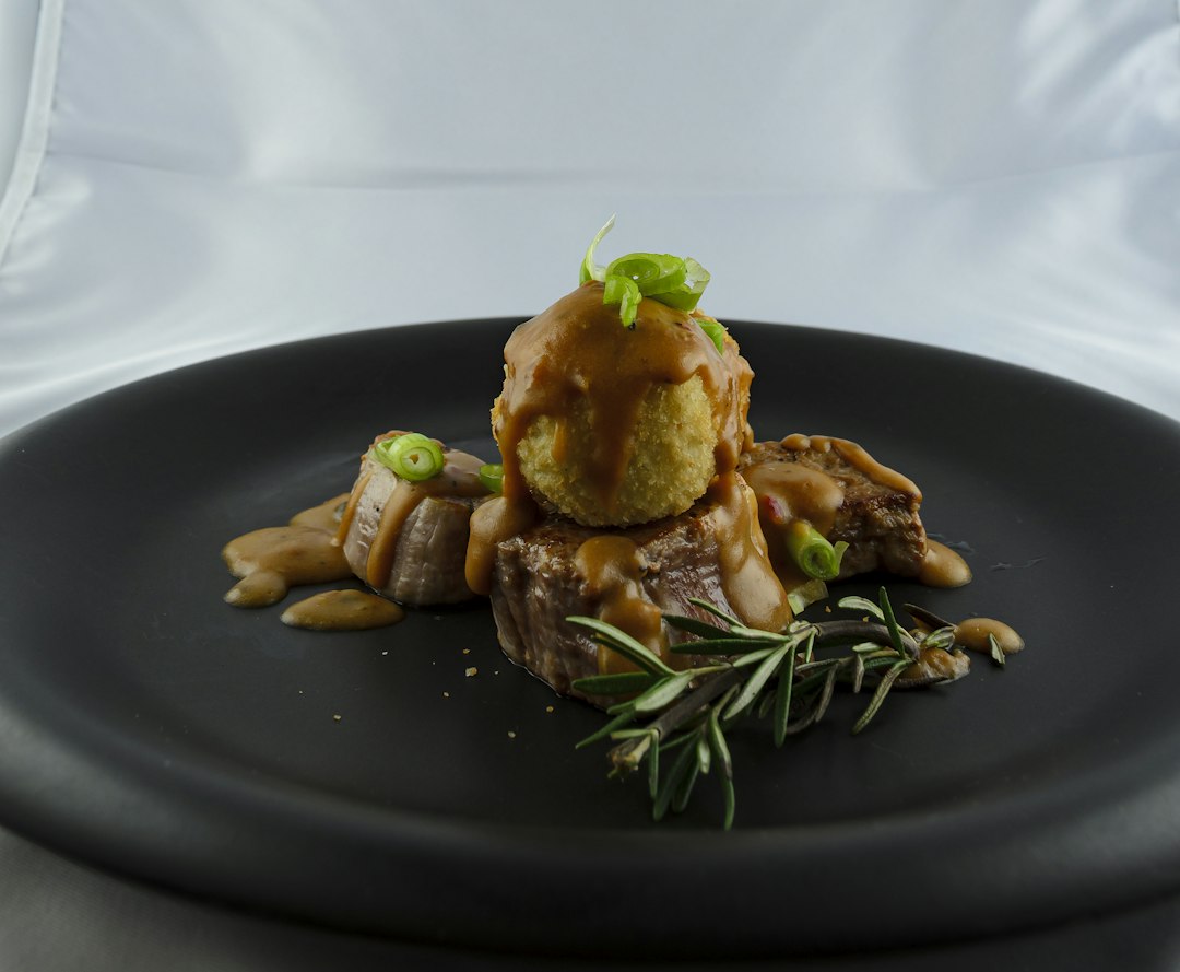 Plated pork tenderloin with sauce and mushrooms as serving inspiration for air fryer pork tenderloin