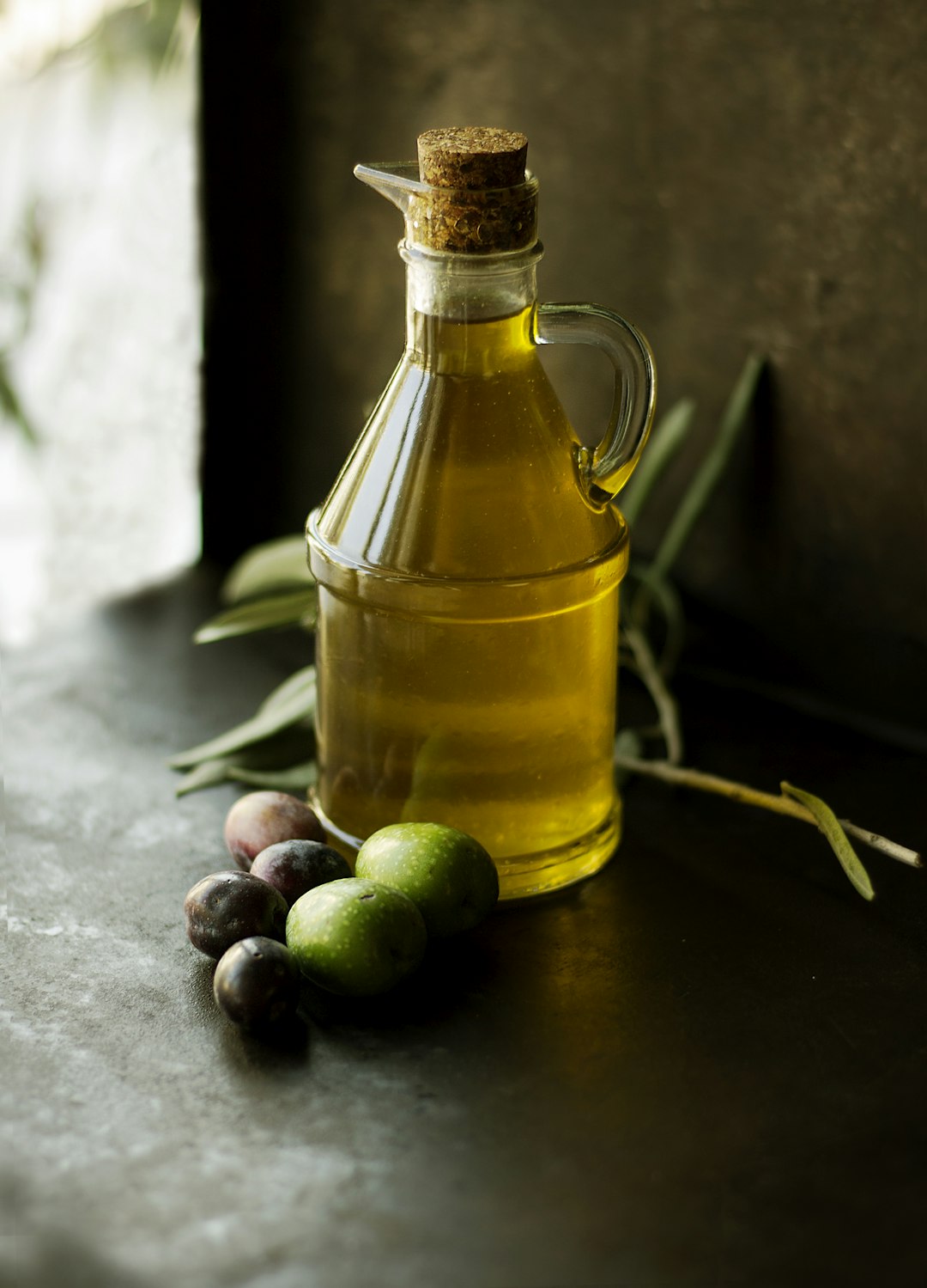 Olive oil in a glass cruet, an ingredient used in this recipe