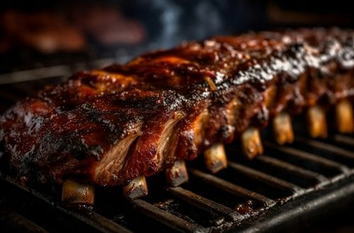 Ribs cooking on a grill with barbecue glaze