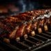 Ribs cooking on a grill with barbecue glaze