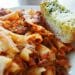 Baked tomato pasta with garlic bread, serving inspiration for baked ziti