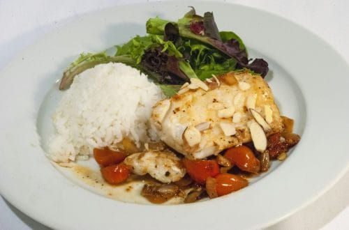 Cooked cod served over stewed tomatoes
