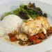Cooked cod served over stewed tomatoes
