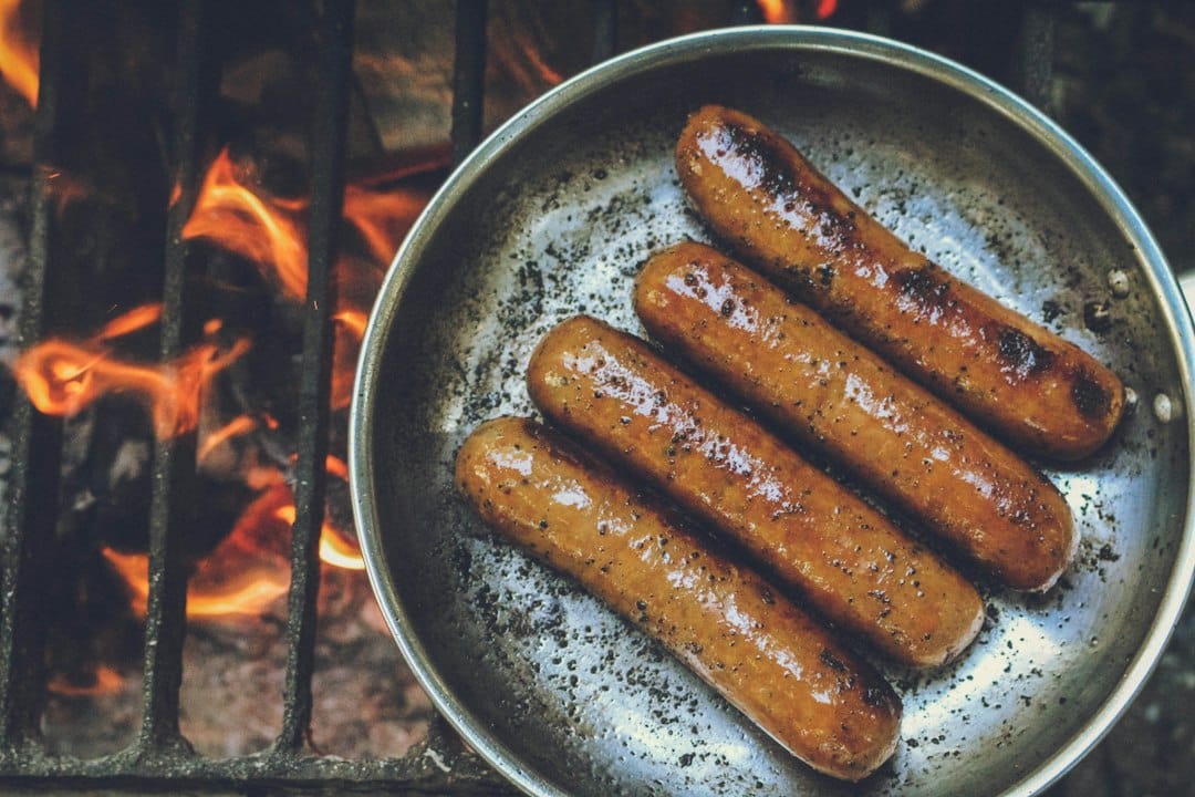 Browned sausage links in a skillet for the sausage done temp guide