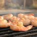 Illustration of shrimp with opaque flesh and browned edges on a grill