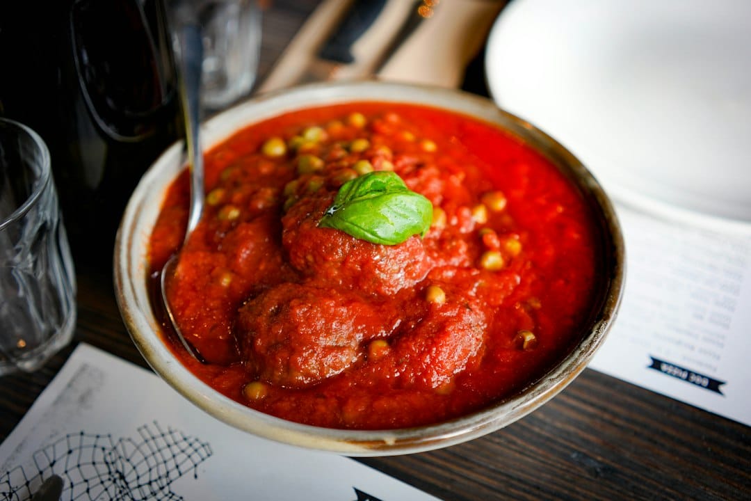 Meatballs in tomato sauce topped with basil