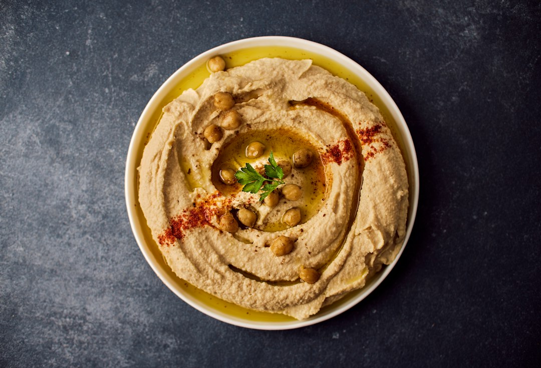 Hummus topped with chickpeas, herbs and olive oil