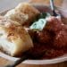 Meatballs in tomato sauce served with focaccia bread and basil