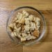 Dried bread pieces in a glass bowl before grinding into breadcrumbs