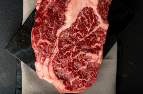 Raw marbled ribeye steak on butcher paper, an ingredient reference for air fryer steak without butter