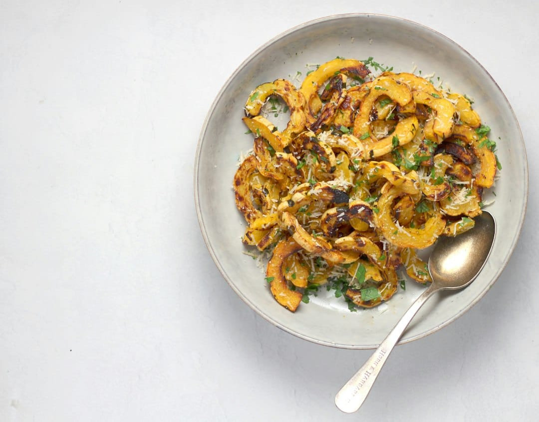 Roasted delicata squash arranged on a serving dish