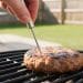 Thermometer checking a grilled turkey burger