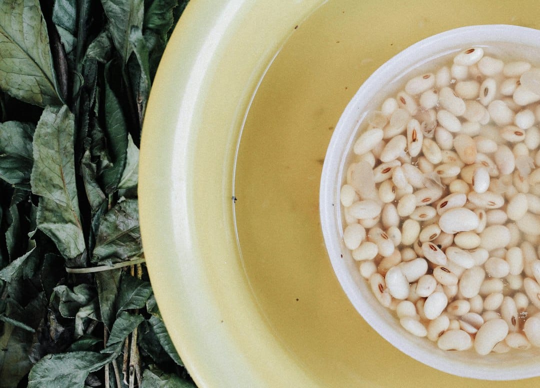 White beans soaking in a bowl before cooking