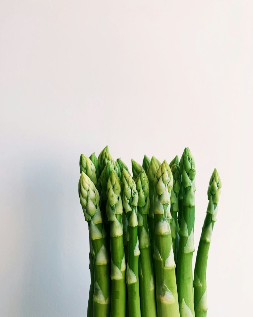 Fresh asparagus spears against a pale background