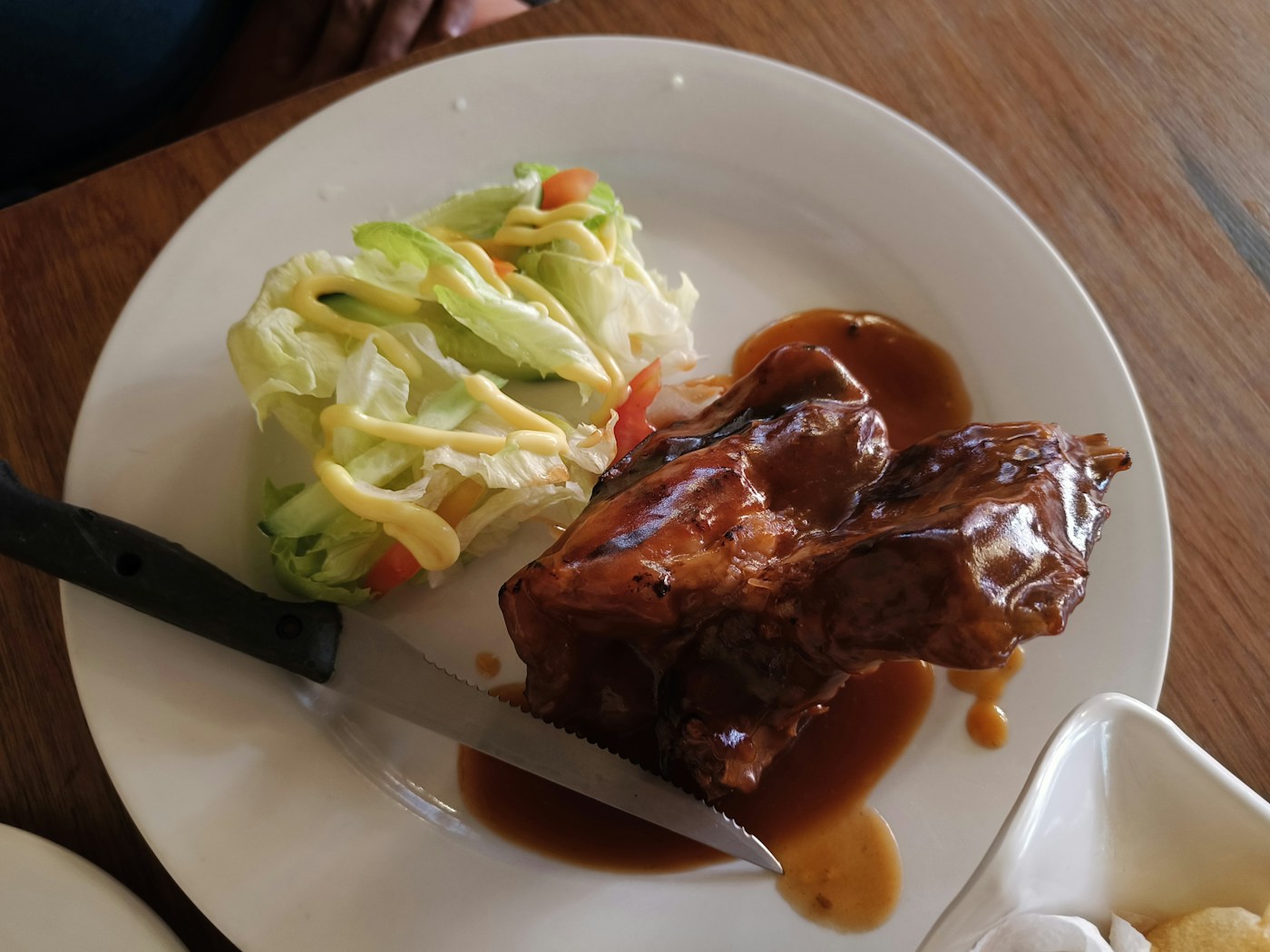 Glazed pork rib portions with salad, a serving idea for how to know when ribs are done