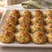 Baked turkey zucchini meatballs without eggs on a platter with tomato sauce alongside