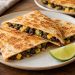 Golden tortilla wedges with a black bean and corn filling visible at the cut edges.