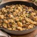 Butter beans and browned cremini mushroom slices in a thick sauce with chopped parsley.