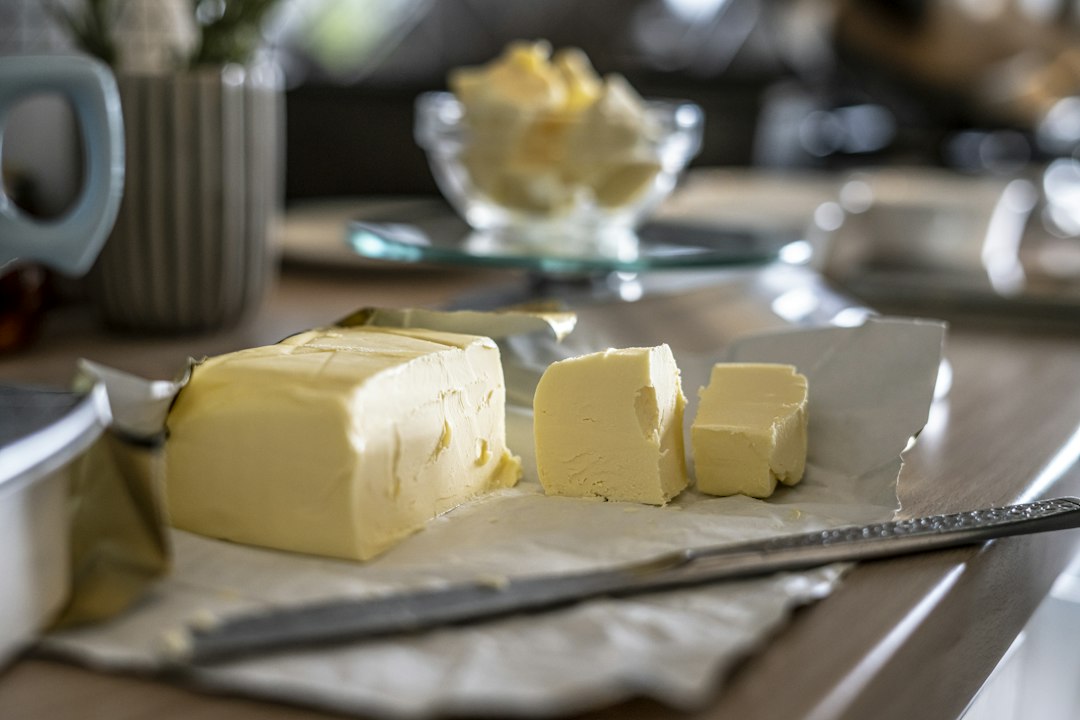 Butter pieces on a wrapper beside a knife for softening without melting