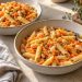 Short penne pasta with whole cannellini beans and soft grated carrot in a light garlic and thyme coating.