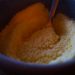 Dry yellow cornmeal in a bowl with a spoon, an ingredient reference for chickpea polenta bowls without tomatoes