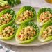 Six romaine lettuce cups filled with partly mashed chickpeas, small apple cubes, diced celery, and parsley.