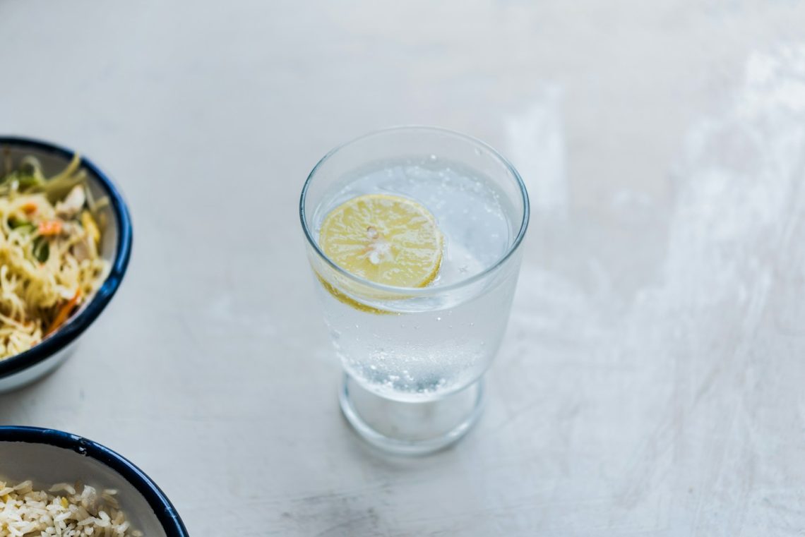 Glass of water with lemon, serving inspiration for DIY electrolyte drinks