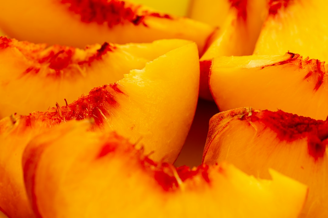 Fresh yellow peach slices with reddish centers for peach cobbler with self rising flour