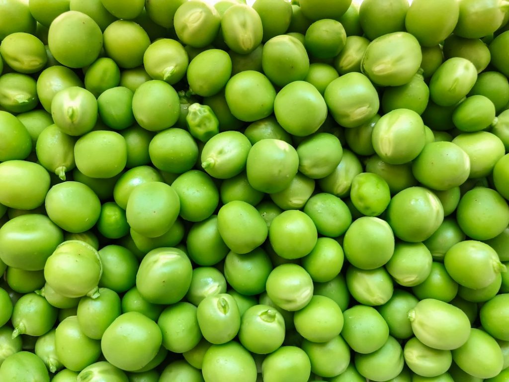 Green peas shown close up.