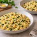 Two bowls of glossy orzo with whole chickpeas, finely chopped spinach and a little lemon zest.