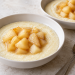 Miso pear semolina pudding for two in white bowls with tender glazed pear pieces