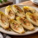 Pan seared Belgian endive without wine on a white plate, topped with parsley