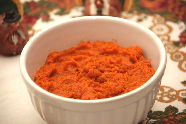 Plain mashed pumpkin in a white bowl, showing the thick consistency of pumpkin puree.