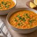 Two bowls of thick golden-orange lentil soup with soft carrot pieces and chopped parsley.