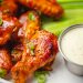 Sauced chicken wings with celery and dipping sauce, serving inspiration for crispy chicken wings