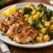 Sheet pan chicken thighs with frozen broccoli and potatoes served with lemon on a platter