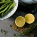 Fresh green beans and halved lemon, ingredient references for sheet pan gnocchi with frozen green beans
