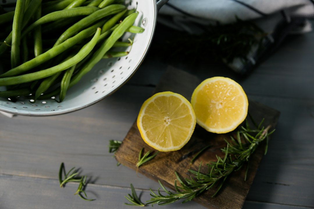 Fresh green beans and halved lemon, ingredient references for sheet pan gnocchi with frozen green beans