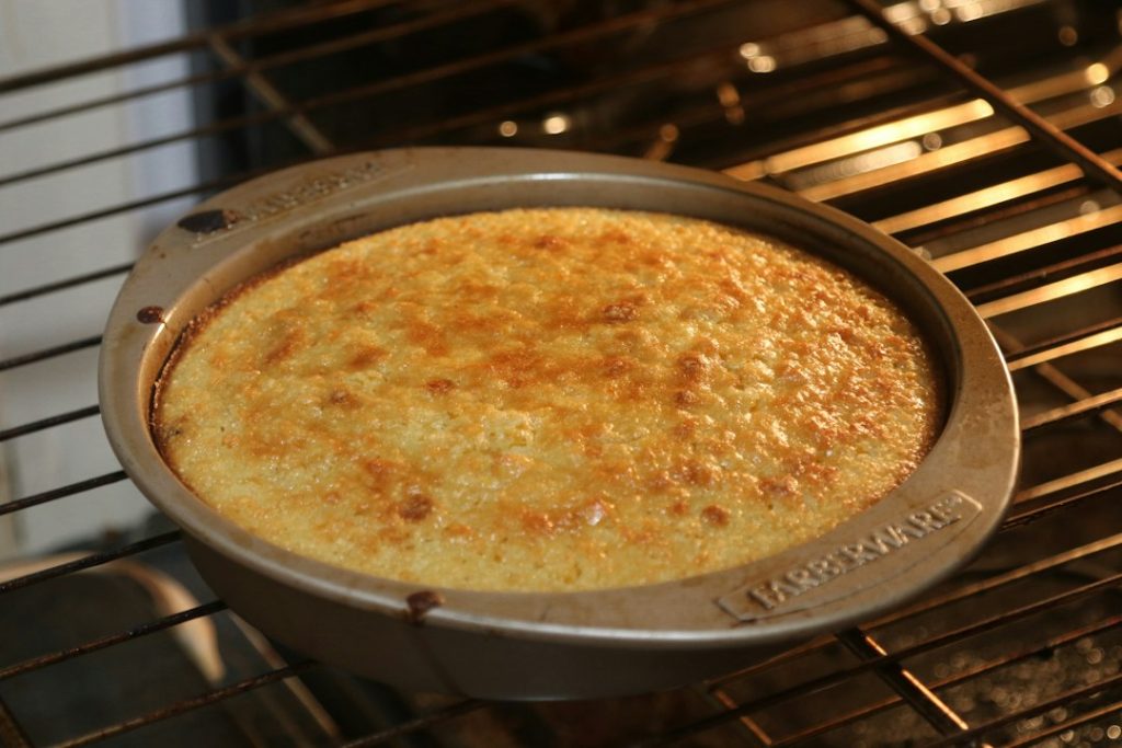 Golden cornbread baking in a round pan, a visual reference for small batch skillet cornbread without eggs