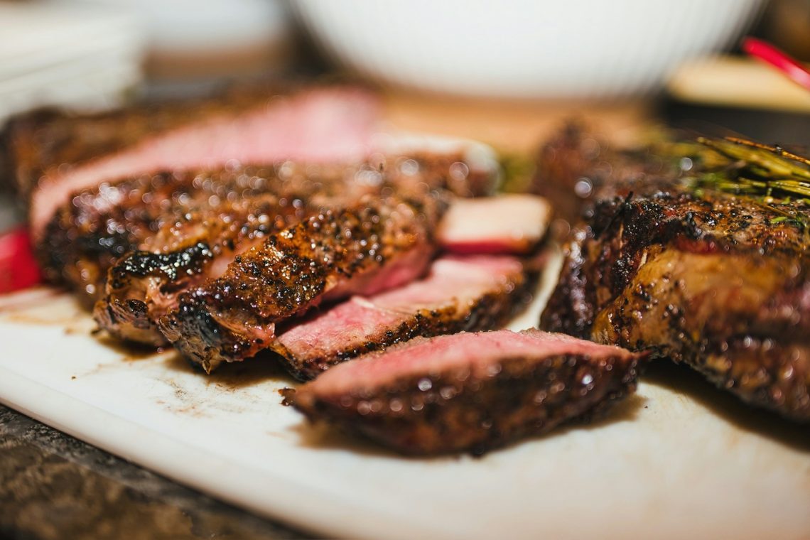 Sliced seared steak with a pink center, featured in the steak doneness temperature chart
