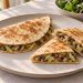 Golden tortilla half-moons filled with browned mushrooms, softened shredded cabbage and onion, with no cheese.